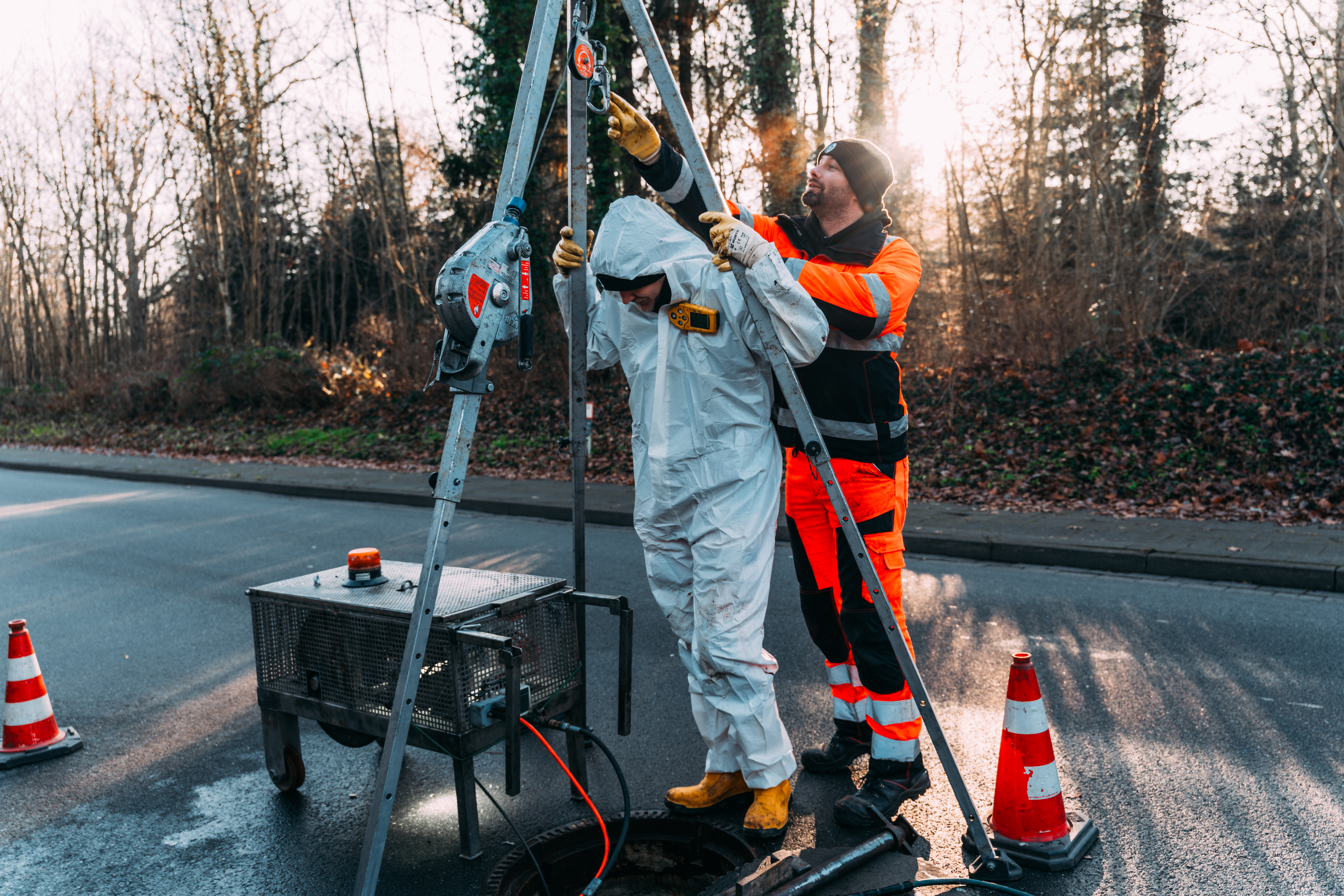 Mitarbeiter beim Kanaleinstieg zur Sanierungsvorbereitung